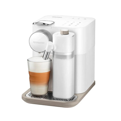 White coffee machine with a glass of layered coffee on a white background